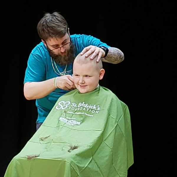 Michael having his head shaved